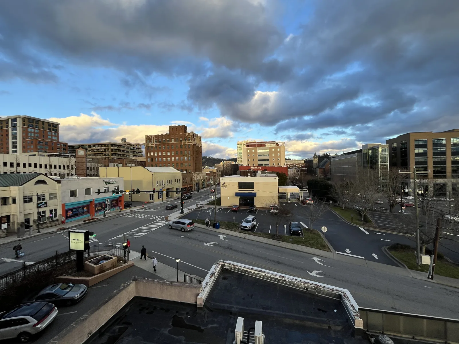 Downtown Asheville seen from above, with its office and apartment buildings and the mountains beyond