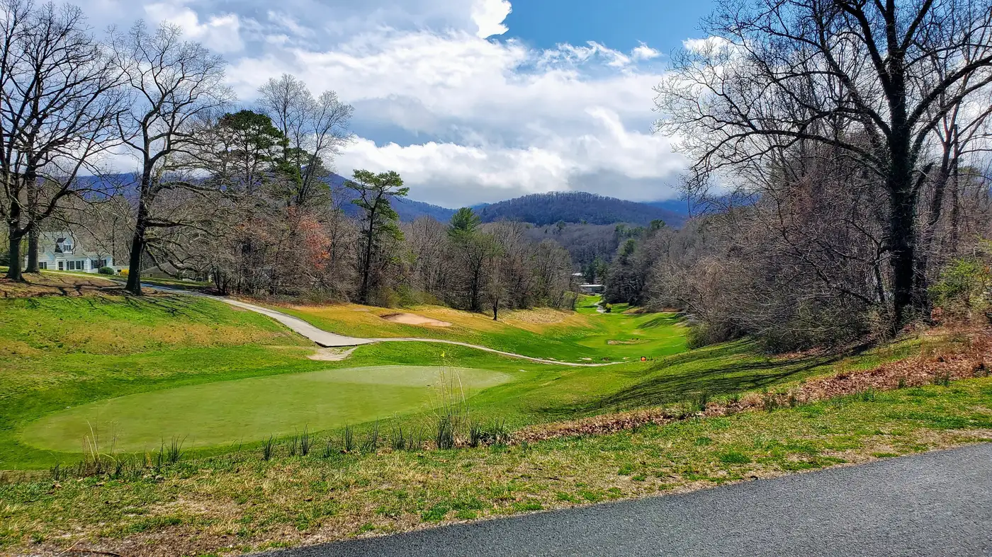 A fairway at the Asheville Municipal Golf Course in East Asheville, with the mountains behind