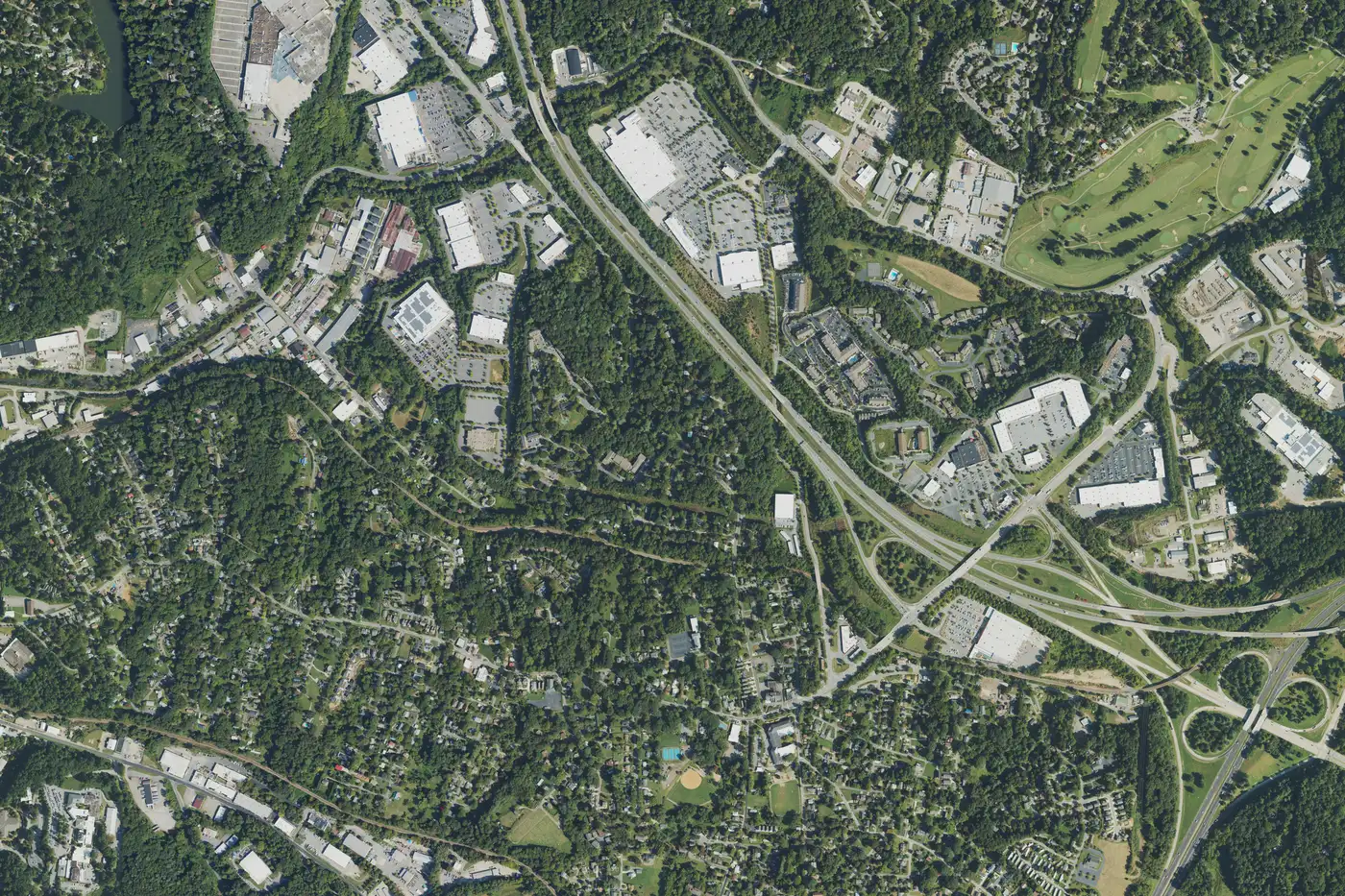 Aerial view of the Oakley area in September 2022, with homes at lower left, shopping centers along the Swannanoa River and the I-240 and I-40 interchange at lower right