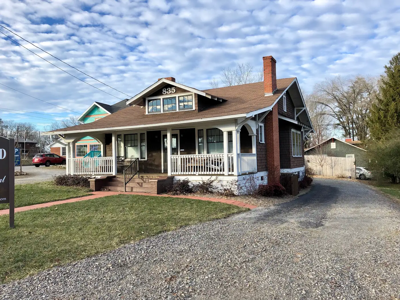 A bungalow with a deep front porch on Haywood Road in West Asheville