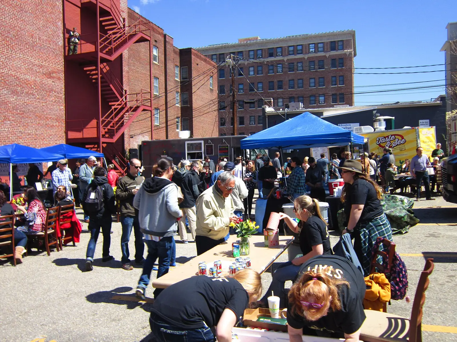 Food trucks and diners at a food truck rodeo in Asheville.