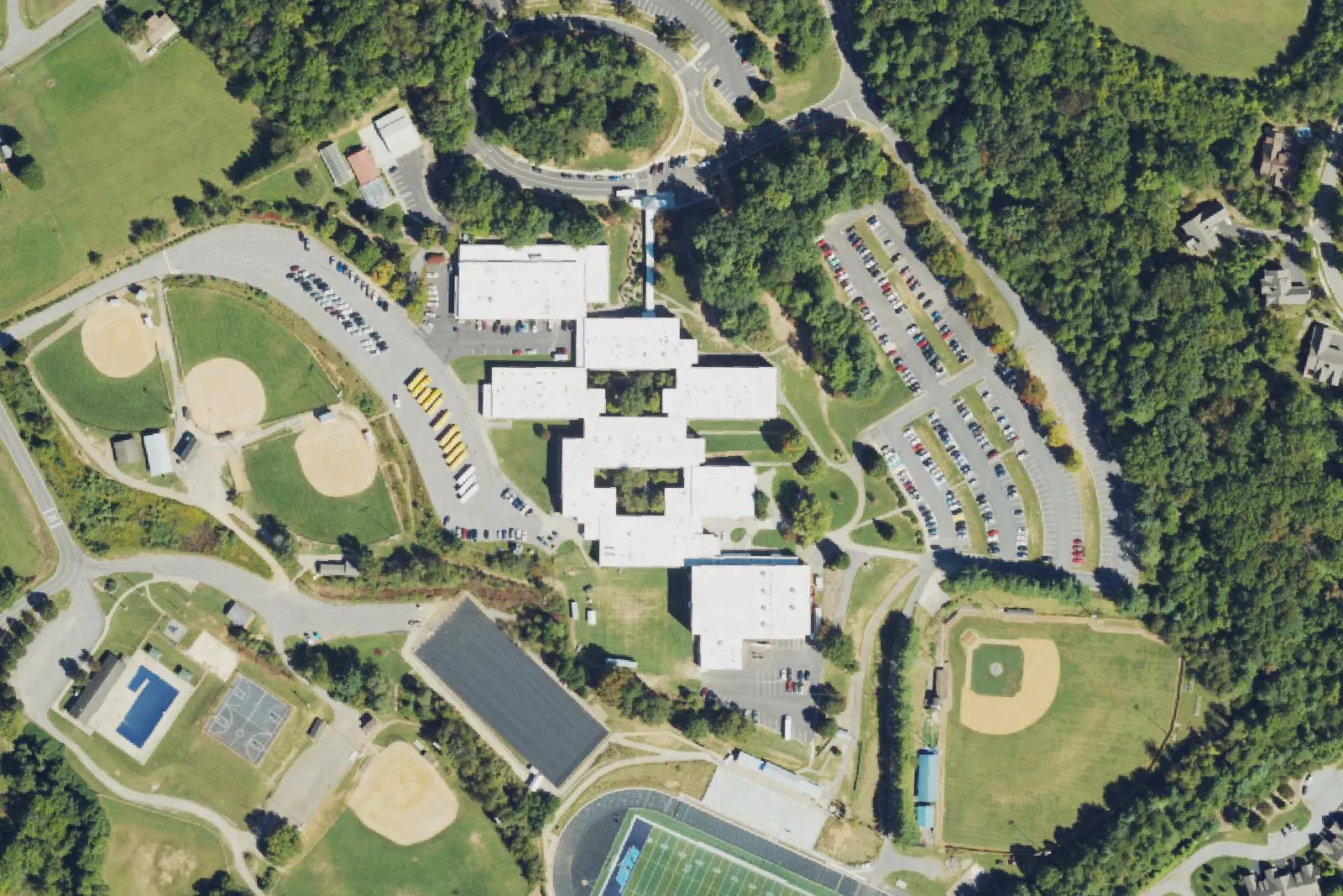 Enka High School's buildings, ball fields and track off Enka Lake Road in Candler, seen from the air