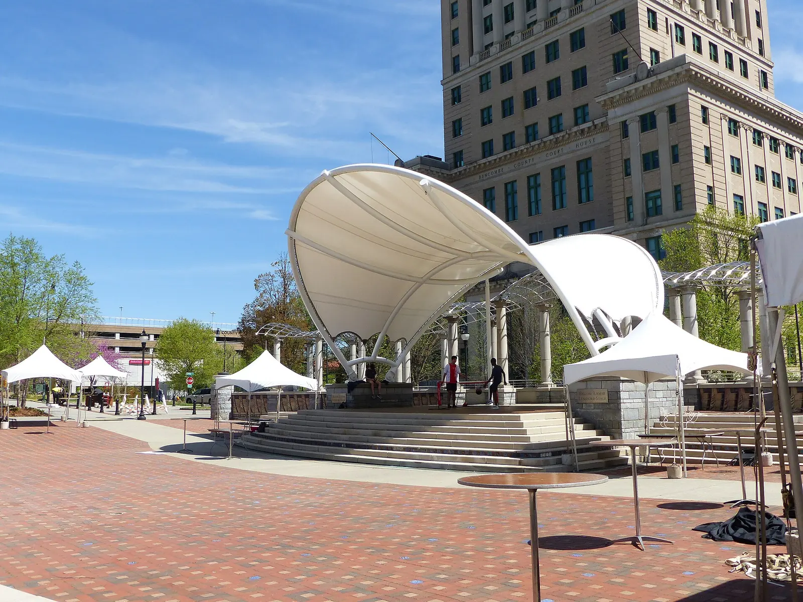 The covered stage and brick plaza in Pack Square Park in downtown Asheville, the park that is home to the Splasheville splash pad.