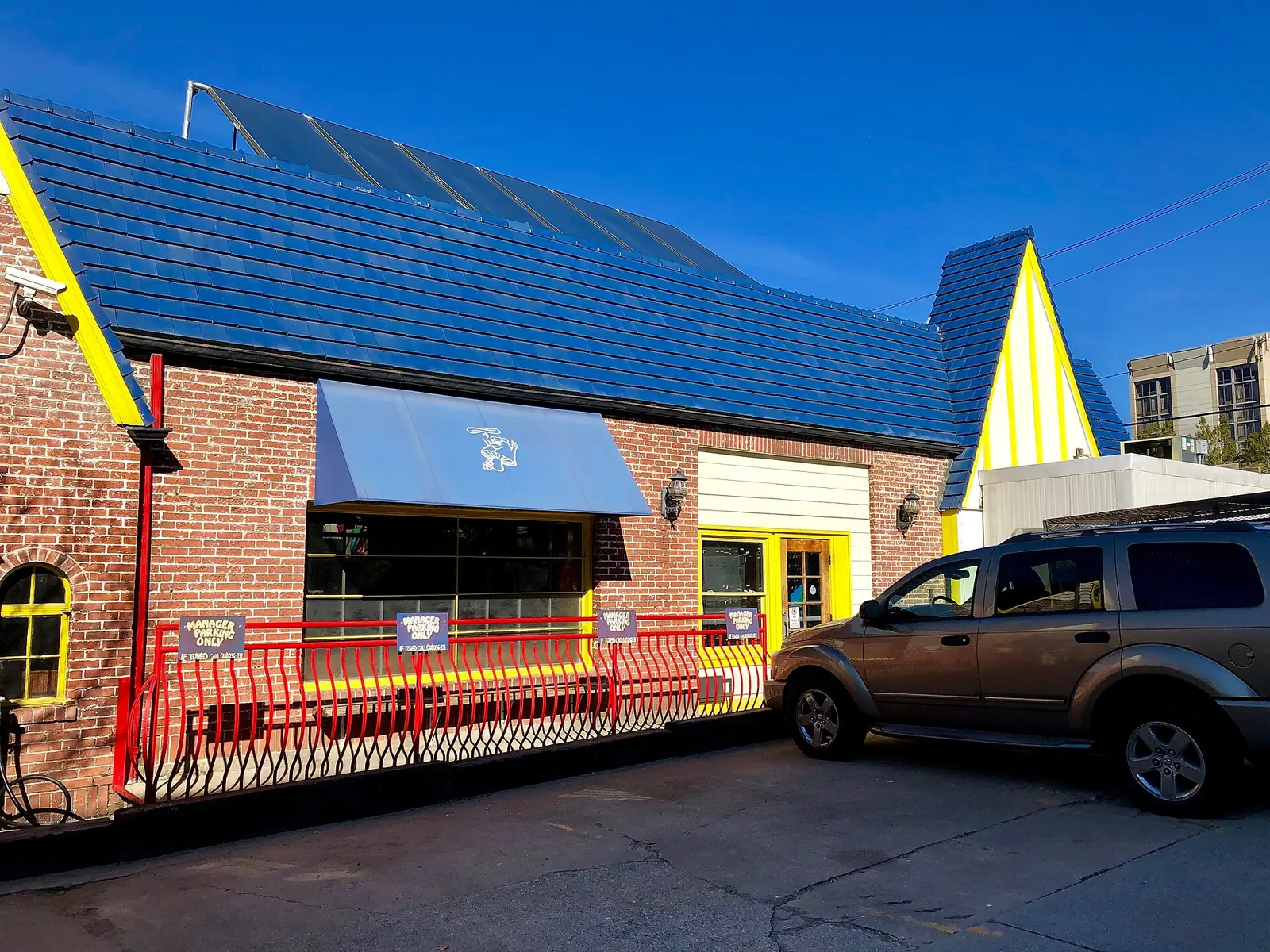 The Mellow Mushroom building on Broadway in downtown Asheville, a former service station with a blue tile roof.